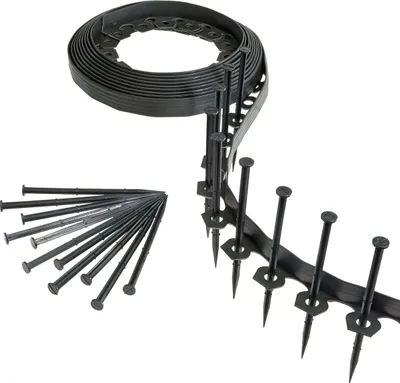 A roll of black flexible garden edging and a pile of black stakes on a white background.