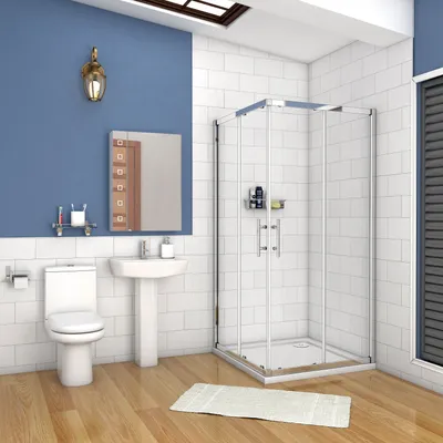 A modern bathroom with a toilet, sink, and shower enclosure.