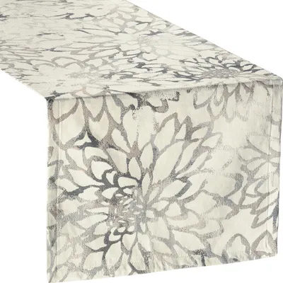 A close-up, angled view of a table runner with a floral pattern.