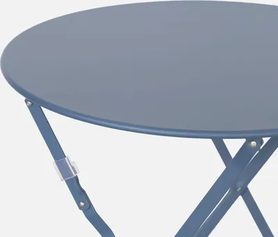 A close-up view of a round, foldable bistro table.