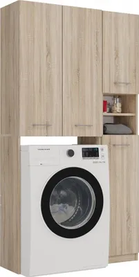 A white washing machine is placed in front of a tall wooden cabinet with multiple doors and open shelving.