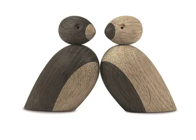 Two wooden bird figures facing each other against a white background.