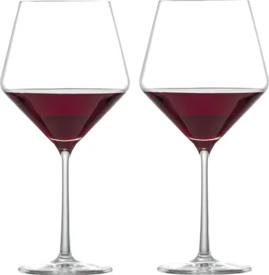 Two wine glasses filled with red wine, presented against a white background.