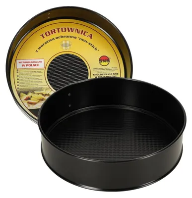 A black round cake pan with a textured interior is shown, with its packaging partially visible behind it.
