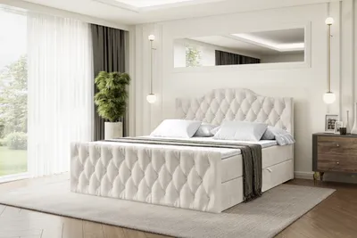 A bedroom scene featuring a large, upholstered bed.