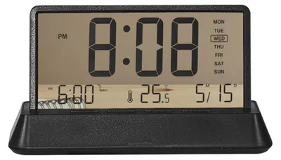 A digital alarm clock displaying the time, date, and temperature.