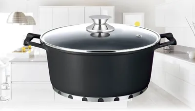 A black pot with a glass lid sits on a kitchen counter.