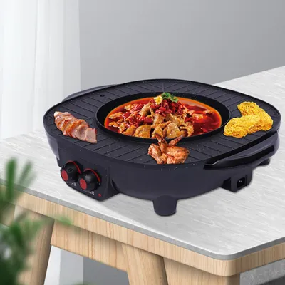 A multi-functional electric grill and hot pot is shown on a table, with food being cooked on it.