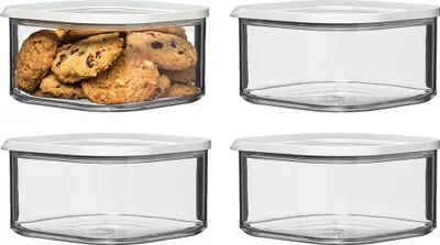 Four transparent square storage containers with white lids, one filled with cookies.