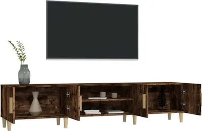 A TV stand with a television mounted above it, and decorative items on the stand.