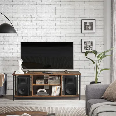 A living room scene featuring a TV stand with a television and speakers.