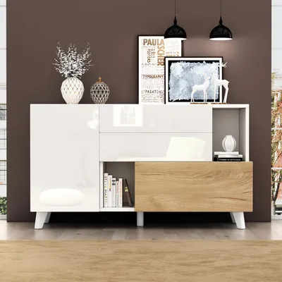A modern sideboard with a glossy white finish and wood-effect drawers, displayed in a room setting with decorative items and artwork.