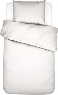 A white duvet and pillow set laid out on a white surface.