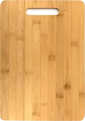A close-up, top-down view of a bamboo cutting board with a handle cutout at the top.