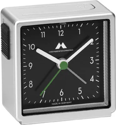 A close-up, front-facing view of a silver and black analog alarm clock.