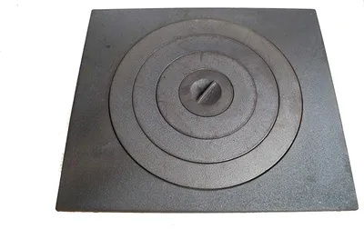 A square cast iron stove plate with concentric circles and a central screw.