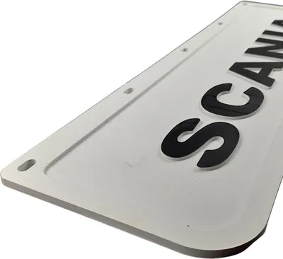 Close-up view of a white license plate with black raised lettering.