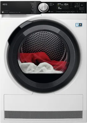 Front view of a white AEG heat pump dryer with a black control panel and a glass door showing red and white laundry inside.