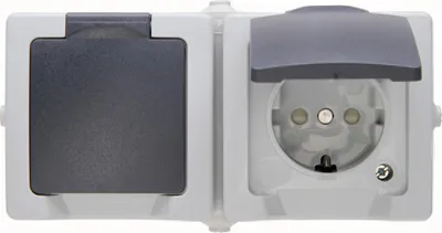 A close-up studio shot of a two-gang electrical outlet with protective covers.