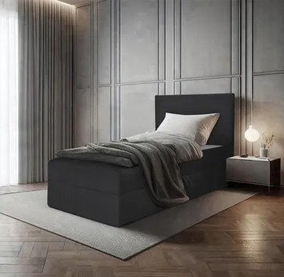 A bedroom scene with a single bed, nightstand, lamp, and curtains.