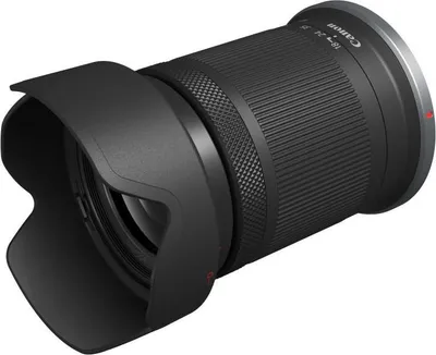 A black Canon camera lens with a lens hood attached, shown from a diagonal angle against a white background.
