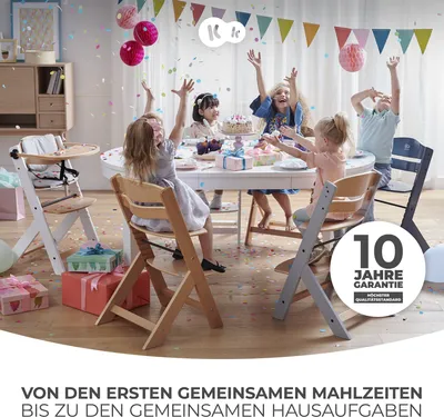 Children celebrating a birthday party with a cake and confetti, with high chairs around a table.