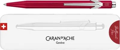 A red Caran d'Ache ballpoint pen shown above its packaging.
