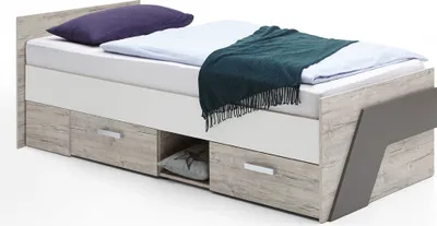 A child's bed with storage drawers and a blanket.