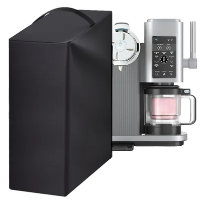 A black protective cover is placed over the left side of a silver and gray ice cream maker, which has a pink mixture in its transparent container.