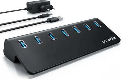 A black USB hub with multiple ports and its power adapter and cables are displayed on a white background.