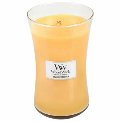 A WoodWick Seaside Mimosa scented candle in a glass jar.