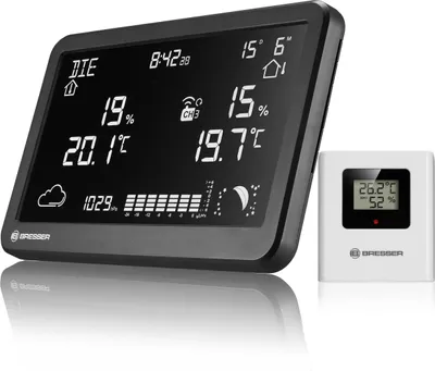 A digital weather station with a separate outdoor sensor, displayed on a white background.