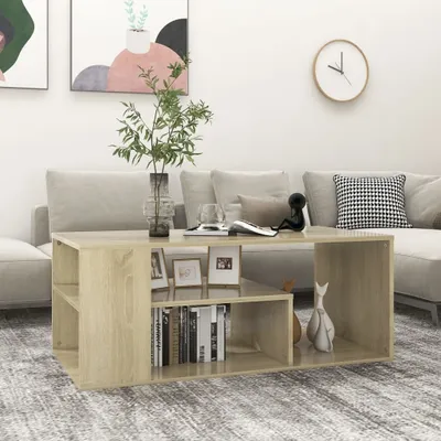 A living room scene with a couch, coffee table, and artwork.