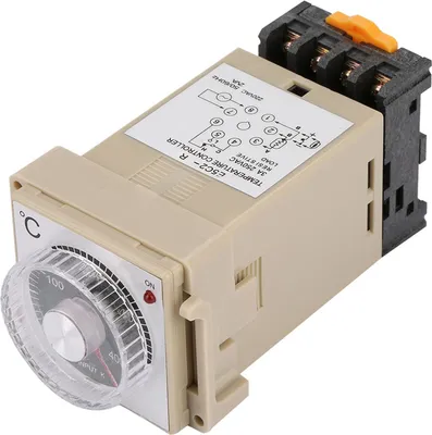 A beige electronic temperature controller with a dial and a black terminal block.