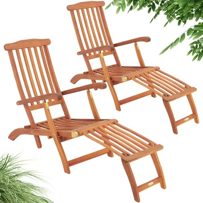Two wooden lounge chairs with footrests are shown against a white background, with some green foliage visible at the top and bottom.
