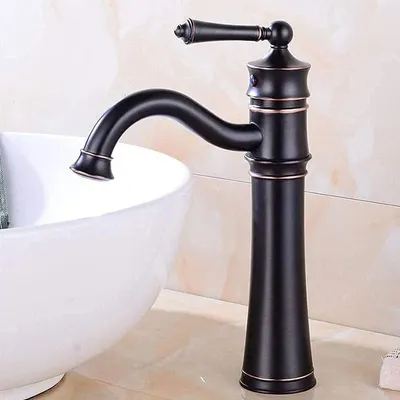 A black vintage-style faucet is shown next to a white sink.