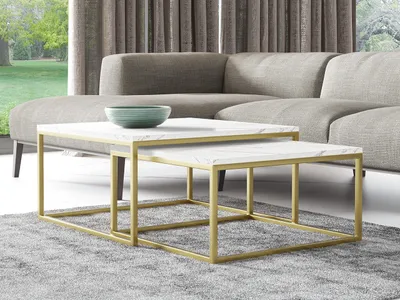 A living room scene with a sectional sofa, two nesting coffee tables, and a decorative bowl.