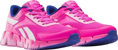 A pair of pink Reebok "X Barbie Zig Dynamica 2" sneakers for children.