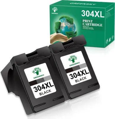 Two black ink cartridges are shown in the foreground, with a green box of ink cartridges in the background.