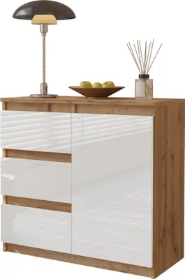 A dresser with a lamp, bowl of fruit, and diffuser on top, set against a white background.