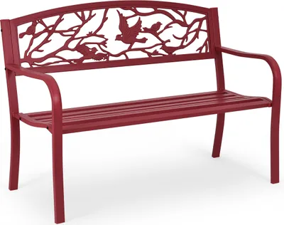 A red metal garden bench with a decorative backrest featuring birds and branches.