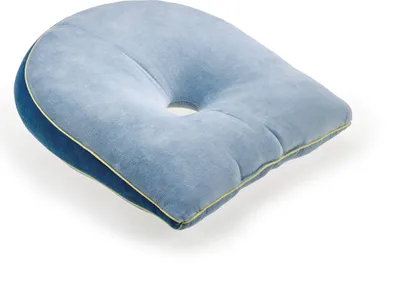 A light blue wedge-shaped pillow with a hole in the center, placed on a white background.