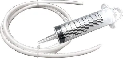 A white flexible tube is coiled around a clear plastic syringe with measurement markings.