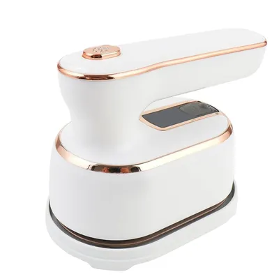 A white and rose gold fabric shaver is shown against a white background. The shaver has a handle on top, a control panel in the middle, and a collection bin at the bottom.