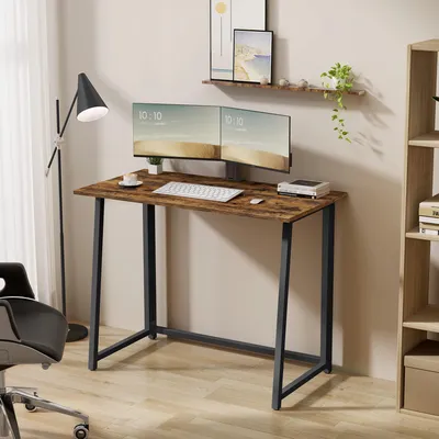 A home office setup with a desk, monitors, and a chair.
