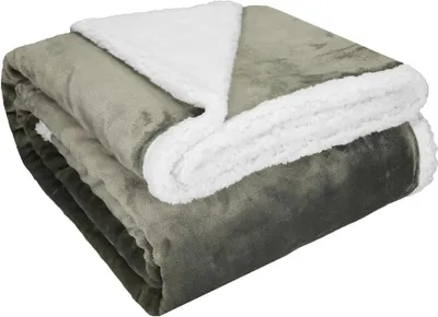 A folded taupe and white sherpa blanket.