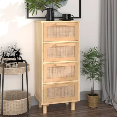 A tall, narrow wooden cabinet with four drawers, each featuring a woven rattan front, is shown in a room setting. A plant is placed to the right of the cabinet, and a small side table with baskets is to the left. A framed picture hangs on the wall behind t