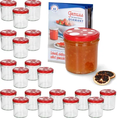A set of glass jars with red and white polka dot lids, some filled with jam, next to a recipe booklet.