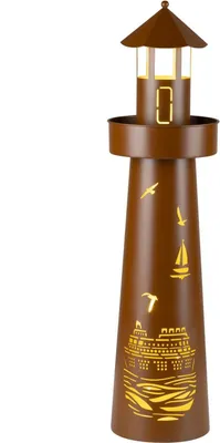A brown lighthouse-shaped decorative lamp with cutouts of ships and birds, illuminated from within.