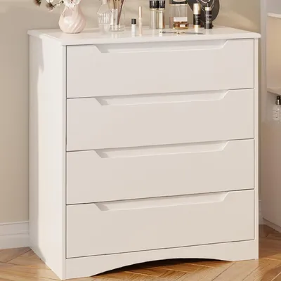 A white dresser with four drawers is shown in a room.